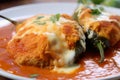 Close-up of spicy Chiles Rellenos stuffed with tender shredded chicken and smothered in a smoky chipotle sauce