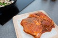 Close up of spicy marinated meat on kitchen table