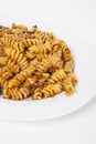 Close-up of spicy pasta in plate over white background