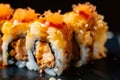 close-up of a spicy tuna roll with tempura flakes and eel sauce drizzled on top