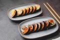 Close up spicy tuna sushi roll on the stone table top. Japanese food and sushi concept Royalty Free Stock Photo