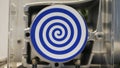 Close up of spinning mechanism creating hypnotic effect. HDR. White rotating circle with dark blue spiral, seamless loop