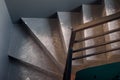 Close up of spiral staircase on black stone wall corner background. Black lobby interior rough concrete stairway with Royalty Free Stock Photo