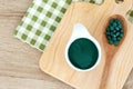 Close up spirulina powder in bowl and spirulina pills in spoon , healthy superfood diet and detox nutrition concept Royalty Free Stock Photo