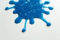 Close up Splash out of Blue Slime Stretching and Mucilage on White Table Royalty Free Stock Photo