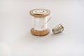 Spool of thread, thimble and sewing needle Royalty Free Stock Photo