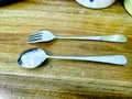 Close up spoon and fork on the wooden table Royalty Free Stock Photo