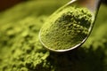 close-up of a spoonful of green superfood powder