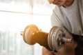 Close up sport man doing dumbbell biceps curl exercise workout in home Royalty Free Stock Photo