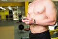 Close-up of Sportive Man After Workout Session Checks Fitness Results Smartphone. Adult Guy Wearing Sport Tracker Royalty Free Stock Photo