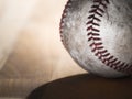 Close up sports background image of an old used weathered leather baseball showing intricate detailing and red laces sitting on a Royalty Free Stock Photo