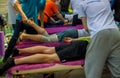 Sports massage. Massage therapist massaging shoulders and legs of athletes, working with Trapezius muscle.