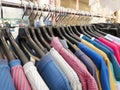 Close-up of sports t-shirts hanging on hangers in a sporting goods hypermarket. Royalty Free Stock Photo