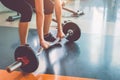 Close up of sports woman lifting weight in fitness gym. Workout exercise and Body build up concept. Barbell lifting and healthy