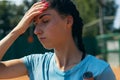 Close-up portrait of female tennis player after hard game