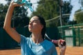 Close-up sportswoman portrait pouring water on her face