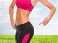 Close up of sporty woman pointing at her buttocks Royalty Free Stock Photo