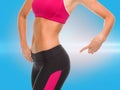 Close up of sporty woman pointing at her buttocks Royalty Free Stock Photo