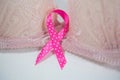 Close-up of spotted pink Breast Cancer ribbon on bra