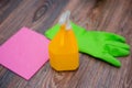 Close-up of a spray bottle, rubber gloves and a wet rag lying on the floor. Royalty Free Stock Photo