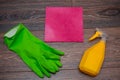 Close-up of a spray bottle, rubber gloves and a wet rag lying on the floor. Royalty Free Stock Photo