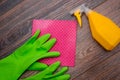 Close-up of a spray bottle, rubber gloves and a wet rag lying on the floor. Royalty Free Stock Photo