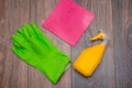 Close-up of a spray bottle, rubber gloves and a wet rag lying on the floor. Royalty Free Stock Photo