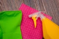 Close-up of a spray bottle, rubber gloves and a wet rag lying on the floor. Royalty Free Stock Photo