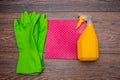 Close-up of a spray bottle, rubber gloves and a wet rag lying on the floor. Royalty Free Stock Photo