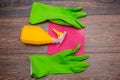 Close-up of a spray bottle, rubber gloves and a wet rag lying on the floor. Royalty Free Stock Photo