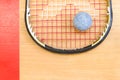 Close up of a squash racket and ball on the wooden background Royalty Free Stock Photo