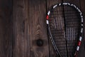Close up of a squash racket and ball on the wooden background Royalty Free Stock Photo