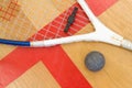 Close up of a squash racket and ball on the wooden background, sport concept Royalty Free Stock Photo