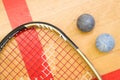 Close up of a squash racket and ball on the wooden background, sport concept Royalty Free Stock Photo