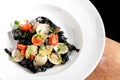 Close-up of squid ink colored tagliatelle