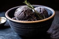 close-up of squid ink ice cream on a black ceramic bowl Royalty Free Stock Photo
