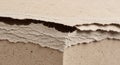 Close-up of a stack of beige handmade paper sheets. The sheets have rough, uneven Royalty Free Stock Photo