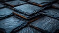 A close up of a stack of black tiles sitting on top of each other, AI