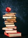 Close-up of a stack of books with a red apple on top Royalty Free Stock Photo