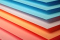 a close up of a stack of colored paper