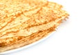 Close up on a stack of crepes french pancakes on a plate on white
