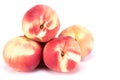 Close up of a stack of delicious and healthy peaches isolated on a white background.