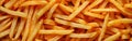 A close-up of a stack of delicious thick french fries piled on top of a table