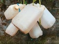 Close-up of a stack of empty jerry cans hanging.