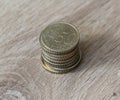 Stack of fifty euro cent coins on wooden background Royalty Free Stock Photo