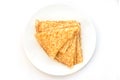 Close up on a stack of folded crepes french pancakes on a plate, white background