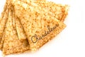 Close up on a stack of folded crepes french pancakes, text chandeleur, isolated on white