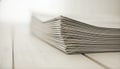 A close-up of a stack of folded newspapers on a wooden table Royalty Free Stock Photo