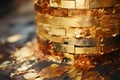 a close up of a stack of gold foil on top of a wooden table