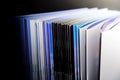 Close up of a stack of hardcover books on a black background